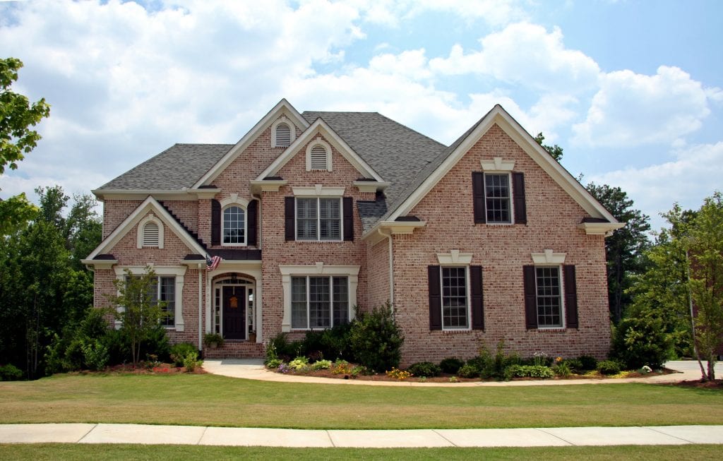 Upper class luxury home with intricate stonework and brick