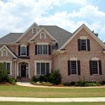 Upper class luxury home with intricate stonework and brick