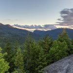 A sunset panoramic view from the summit of Mount Jo, overlooking Heart Lake, Mt. Colden, and Algonquin and Wright Peaks in the High Peaks region of the Adirondack Mountains near Lake Placid, NY